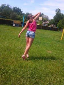 Teen JB in Denim Shorts Stretching on a Countryside Football Field
