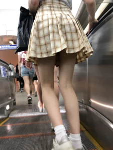 Cute Blonde Candid Girl in a Skirt Flashing Panties on a Subway Escalator Photos