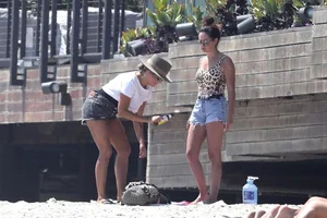 Ashley Tisdale in cheetah print swimsuit on the beach in Malibu