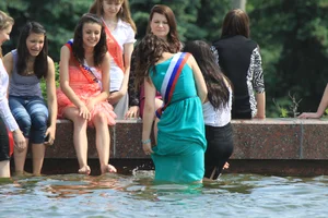 Young College Girls in Dresses, Skirts And Pantyhose Having a Good Time By the City Fountain