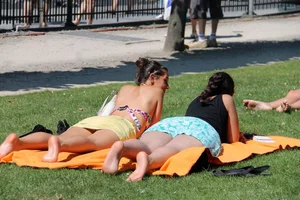 Two Cute Candid Girls Lying on the Park Lawn Creepshot