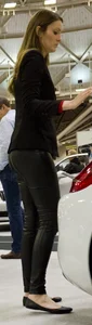 Pretty car saleswoman in tight shiny black pants with nice ass