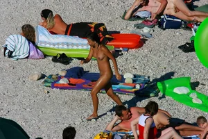 FKK Nudists playing in the water with floater