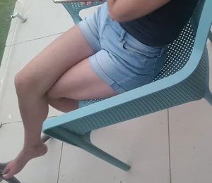 Feet and Legs in Denim Shorts - Girl Sitting With Crossed Legs