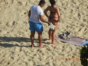 Big booty beach babe laying out in thong