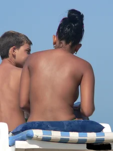 Hot ass topless beach girl with great tits lets her little brother oil up her ass in thong bikini