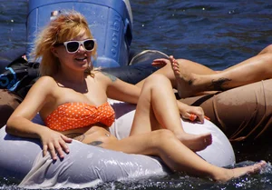 Sexy party girls in bikinis on a lake