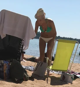 Swedish beach blonde girl in white and green bikini