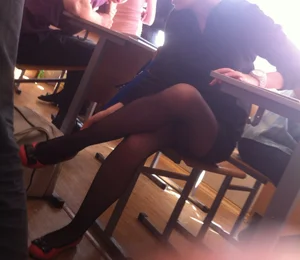 Girl in Black Pantyhose and Flats Sitting Cross Legged at the Desk in Classroom College Creepshot