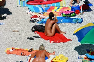 Ula FKK Sexy brunette on a nude beach topless, bottomless and with blue thong