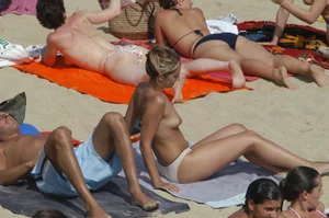Topless girls on a beach in Barcelona