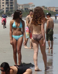 Brunette and redhead on the beach in bikinis looking sexy