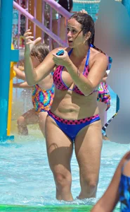 Milf at the pool in a thong bikini with big boobs looking hot