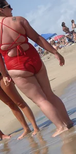 Fat chick on the beach in a red swimsuit