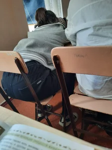 Teen in Jeans Sitting at Her Desk in Class Sneaky Photo