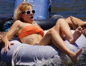 Sexy party girls in bikinis on a lake