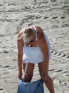 Mature blonde lady on a nude beach with big boobs