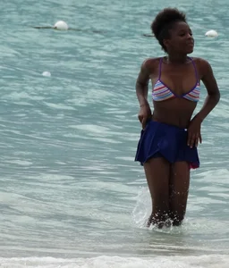 Candid black family, milf and teens on the beach in bikinis
