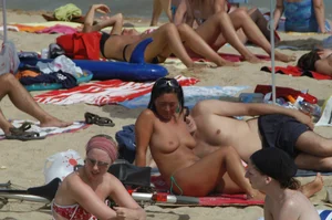 Topless girls on a beach in Barcelona