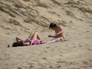Topless beach girl with nice titties with her friend in a bikini