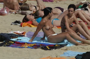 Topless girls on a beach in Barcelona