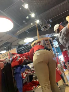 Bunch of girls in various outfits at a Cardinals baseball game