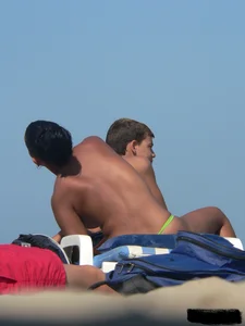 Hot ass topless beach girl with great tits lets her little brother oil up her ass in thong bikini