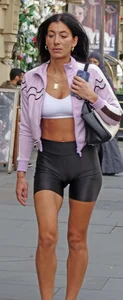 [It’s an older Milf, but it checks out] tight toned body showing off her ass, thigh gap & cameltoe in shiny shorts