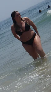 Thick beach babe with big tits in a thong bikini