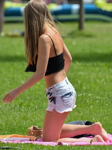 Sexy blonde girl in the park playing volleyball in her skimpy bikini