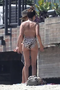 Ashley Tisdale in cheetah print swimsuit on the beach in Malibu