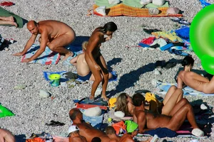FKK Nudists playing in the water with floater