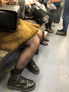 Girl with Nice Legs in Dark Pantyhose with Hearts Ornament in the Subway Train Candid Pics