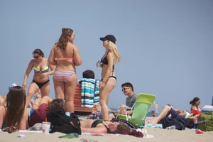 Two thick white girls in bikinis on the beach with big asses