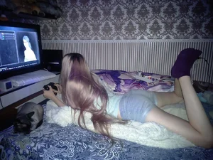 Cute Teen Gamer Lying on Bed in Socks and Shorts Home Candid