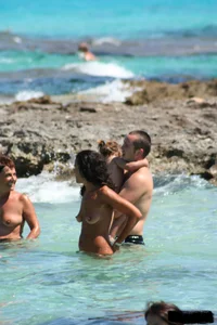 Nude beach ladies in the water showing their tits