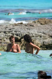 Nude beach ladies in the water showing their tits