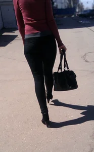 Girl in Tight Jeans on High Heels Walking Down the Street