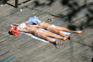 Two teens stripping and going topless to tan