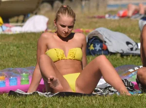 Blonde looking sexy in a yellow bikin