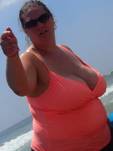 Thick lady on the beach with huge tits