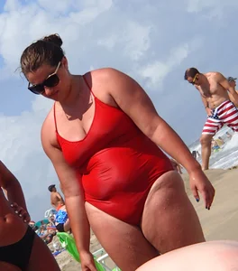 Fat chick on the beach in a red swimsuit