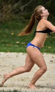 Cute girl playing volleyball in her little bikini