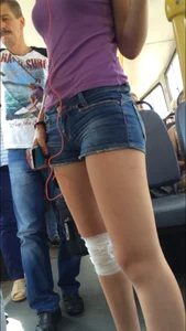 Candid bus teen with a bandaged knee wearing denim shorts with hot slim legs creepshots