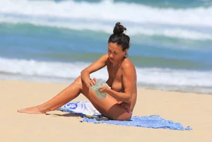 Sexy girls topless on a nude beach showing their nice tits