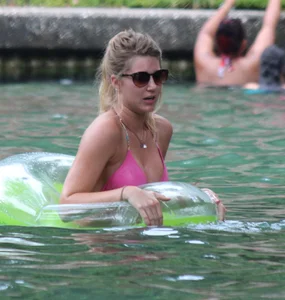 Blonde bikini girl at the pool in pink bikini top with amazing tits