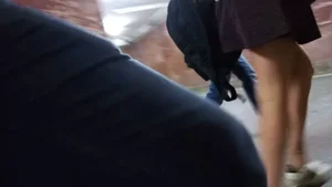Hot legs and ass of a girl wearing a skirt, walking up the stairs on the street video