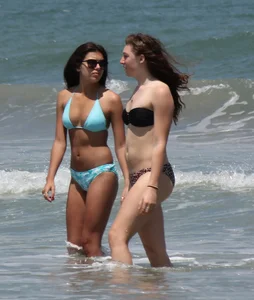 Brunette and redhead on the beach in bikinis looking sexy