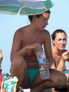 Bunch of sexy babes on the beach topless and in thong bikinis