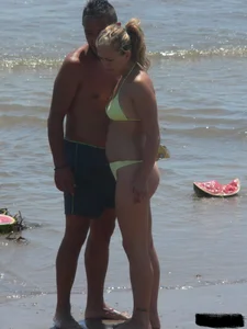 Sexy blonde on the beach in a yellow thong bikini
